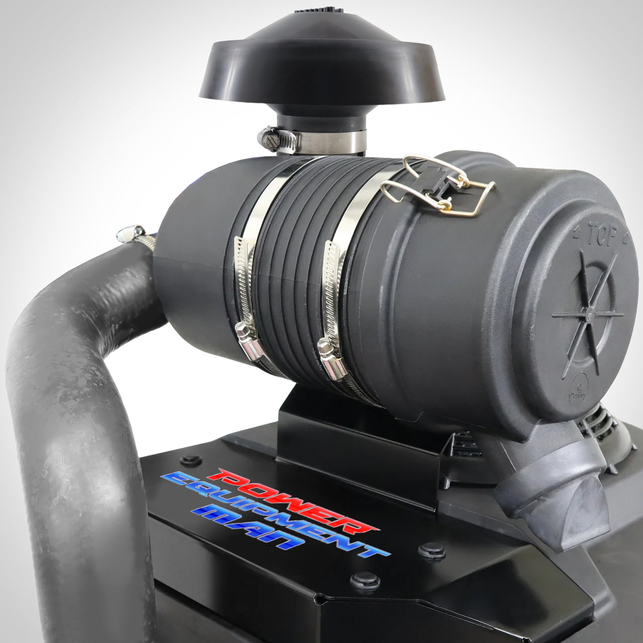 An air filter upgrade kit installed on a Kawasaki FS engine, featuring a black air filter housing and mounting bracket with visible branding.